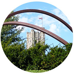 UC Tower viewed through campus artwork