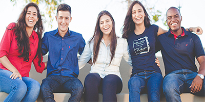 Diverse students sitting and smiling